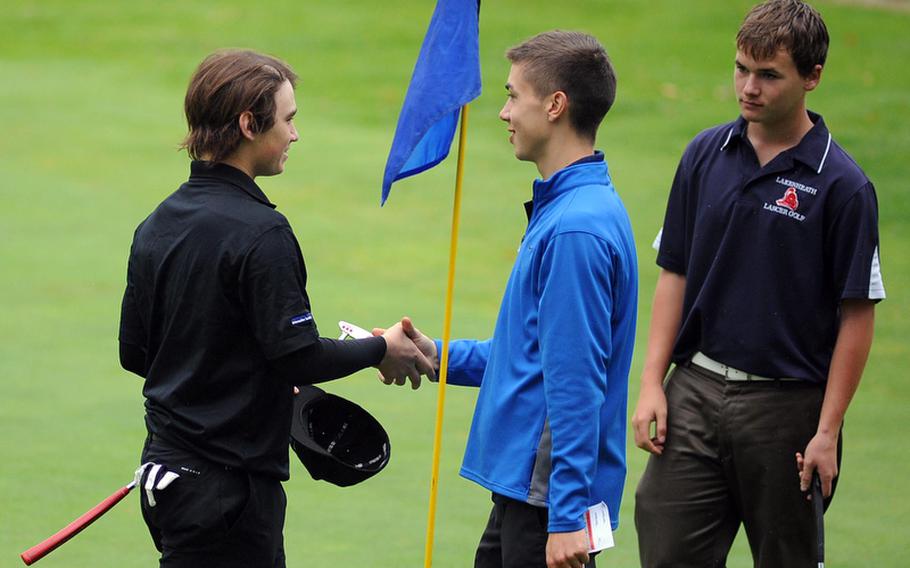 Last year's champion Joe Patrick of Heidelberg, left, congratulates the 2012 DODDS-Europe boys golf champion Everett Plocek of Ramstein. Plocek, who was third behind Patrick and teammate Christian Gunia coming into the final round, shot a total 94 modified Stableford, Friday to take the championships. Patrick finished fourth. At right is Lakenheath's Kyler Zachery, who finished sixth.