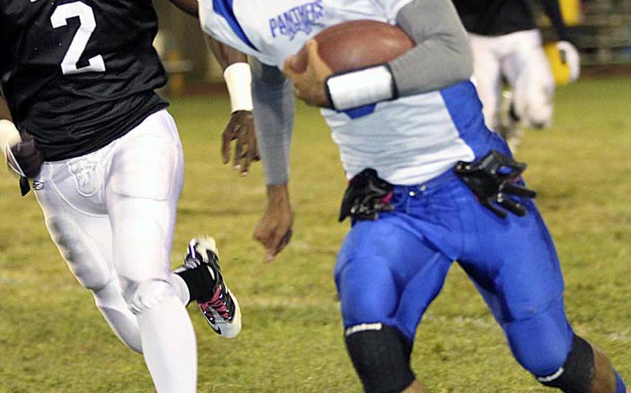 Yokota quarterback Stanley Speed leaves Zama American defender David Coleman in his trail during Friday's DODDS Japan/Kanto Plain Association of Secondary Schools football game at Camp Zama, Japan. Yokota won 39-12.