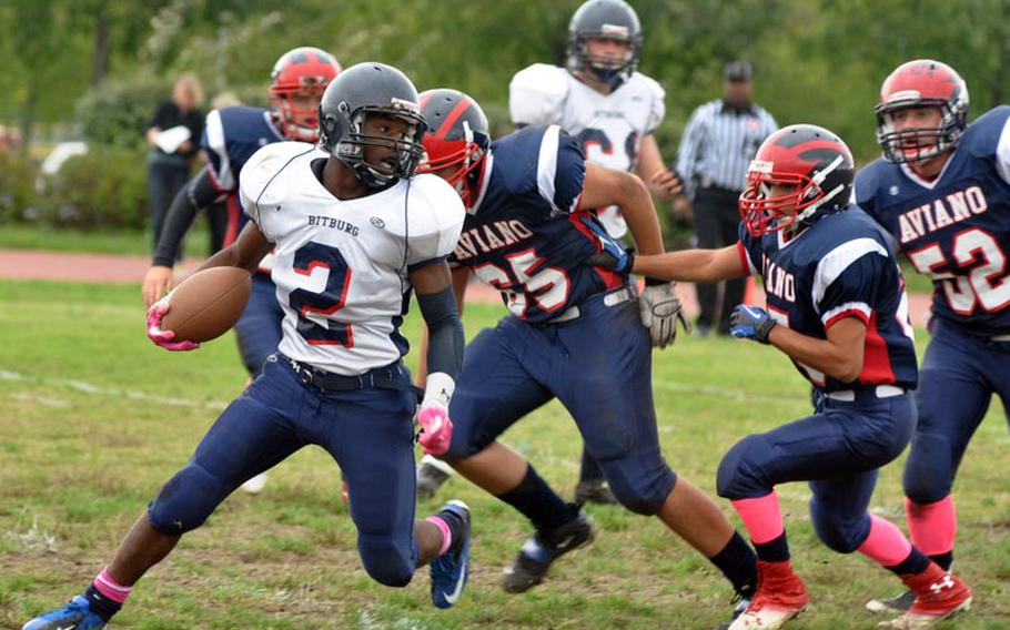 Bitburg's C.J. Evans cuts back against the field, throwing the Aviano defense into confusion Saturday in the Barons' 50-6 victory over the Saints. Evans had 288 yards rushing and scored five touchdowns.