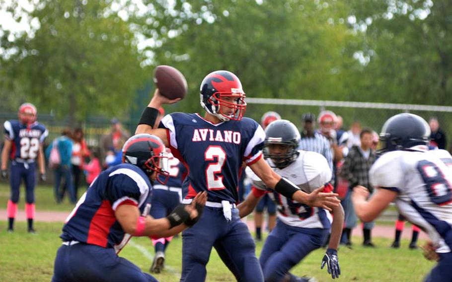 Aviano quarterback Mike Trujillo goes back to pass in the Saints' 50-6 loss to Bitburg on Saturday. Trujillo passed for 93 yards and a touchdown in the first half, but threw two interceptions and didn't complete a pass in the second half before the game was called.