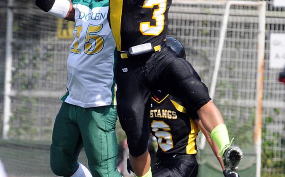 American School In Japan safety Ken Yajima intercepts a pass in front of teammate Kazu Chen and Robert D. Edgren receiver Khalil Williams during Saturday's high school football game at American School In Japan Chofu campus, Tokyo. ASIJ won 47-14 to sweep the season series from the Eagles.