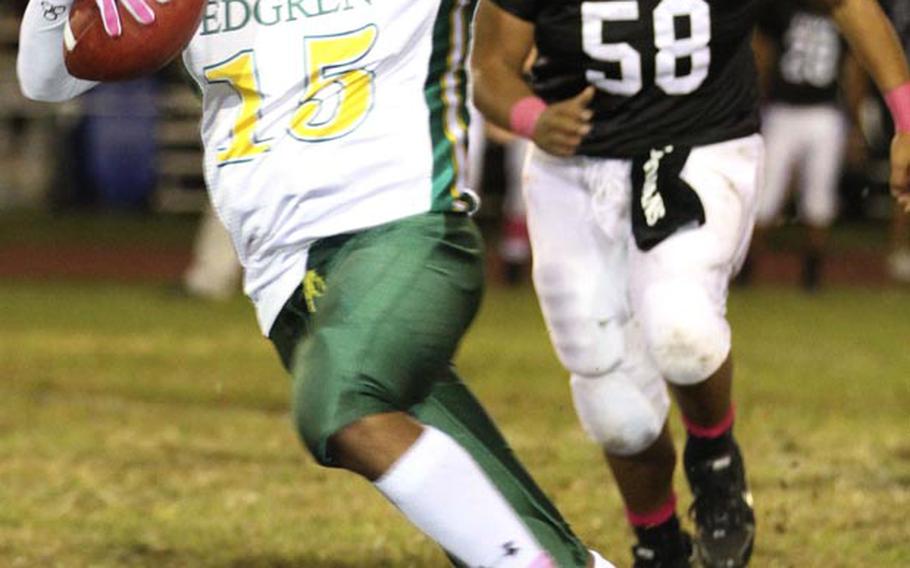 Robert D. Edgren running back Khalil Williams evades Zama American defender Yoshi Nicolas during Friday's game at Camp Zama, Japan. Zama won 40-17 and clinched host rights to the Nov. 10 D-II title game.