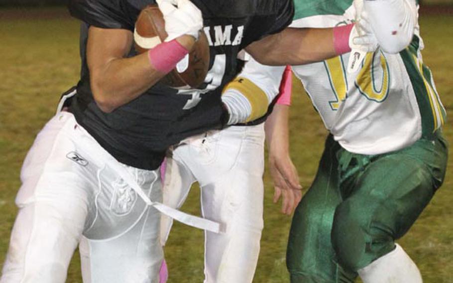 Zama American running back Holden Limas runs through the tackle of Robert D. Edgren defender Hunter Matthews during Friday's game at Camp Zama, Japan. Zama won 40-17 and clinched host rights to the Nov. 10 D-II title game.