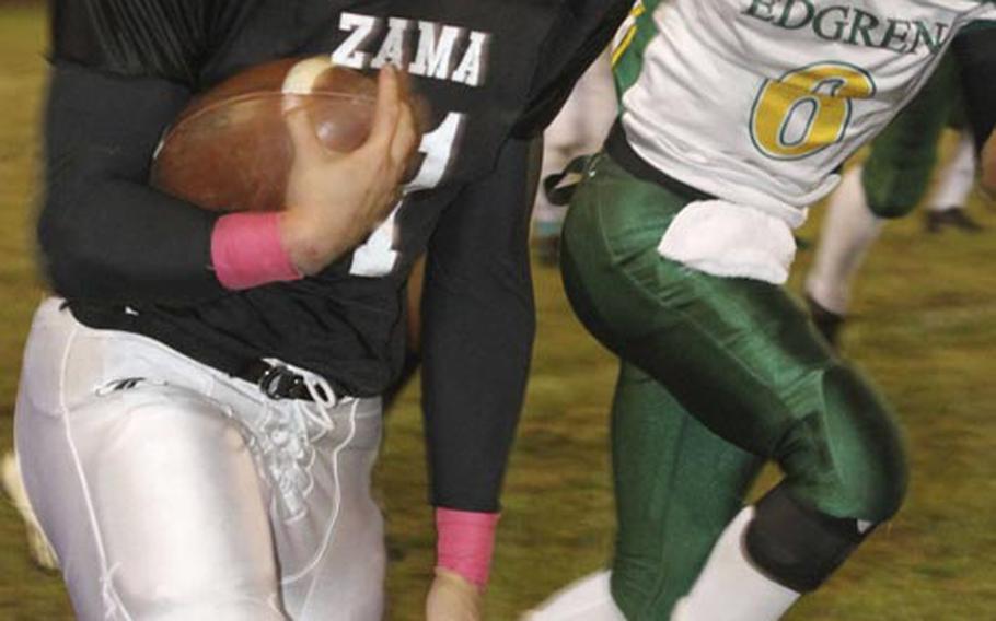 Zama American running back Andre Encarnacion tries to outrun Robert D. Edgren defender Tristan Jefferson during Friday's game at Camp Zama, Japan. Zama won 40-17 and clinched host rights to the Nov. 10 D-II title game.