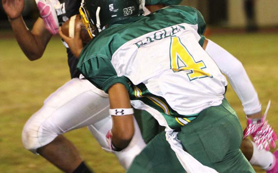 Zama American running back Rafael Morales runs past Robert D. Edgren defender Tyrone Bacalso during Friday's game at Camp Zama, Japan. Zama won 40-17 and clinched host rights to the Nov. 10 D-II title game.