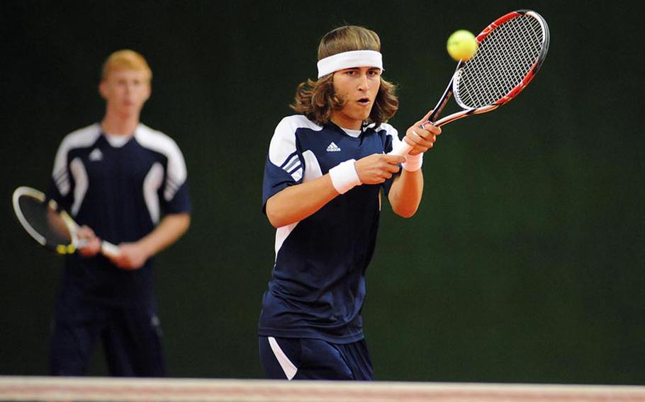 Heidelberg's Jack Kolodziejski returns a AFNORTH shot as teammate Wylder Raney watches. The top-seeded duo defeated Luke Bonenclark and Brooks Wolfe 6-1, 6-0 in the second round match at the DODDS-Europe tennis championships.