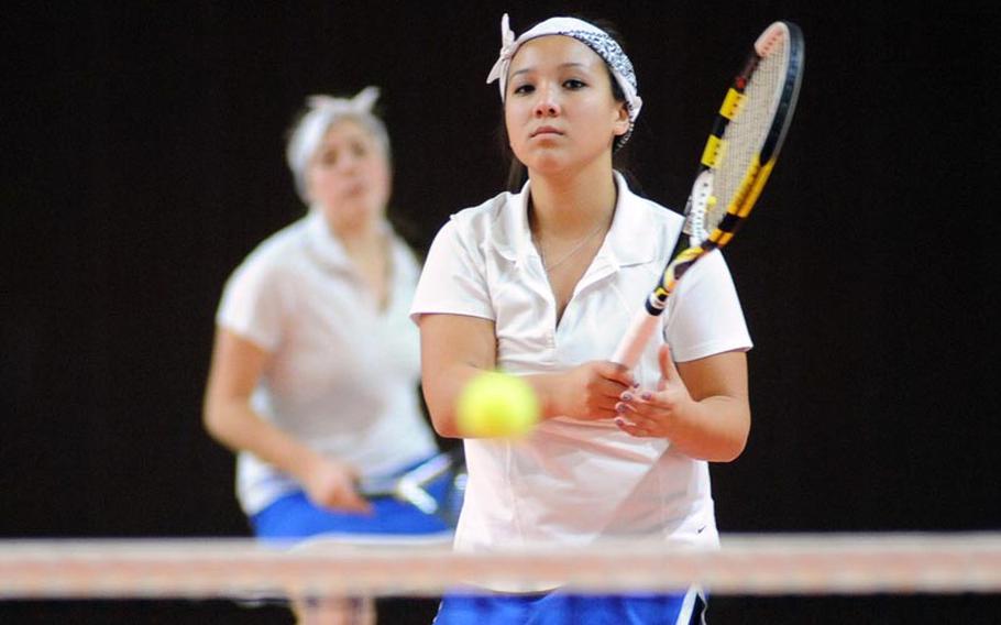 Wiesbaden's Peyton Taylor watches her ball drop over the net in a second-round  match against Vicenza's Jenna and Samantha Pimentel at the DODDS-Europe tennis championships, Thursday. Taylor and partner Kate Connors, seen in the background won 6-1, 6-3.