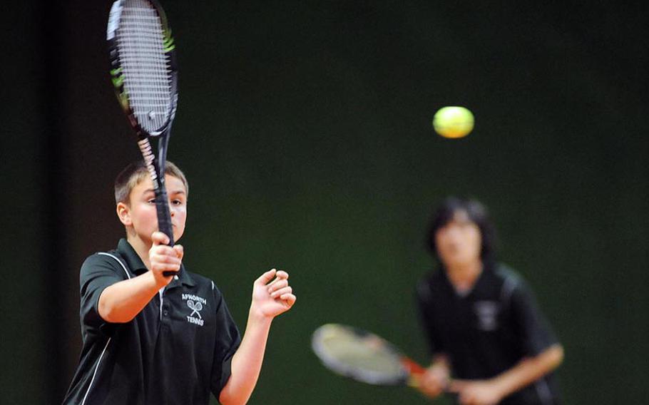 AFNORTH's Luke Bonenclark watches his ball sail over the net in a second-round match against Heidelberg's Jack Kolodziejski and Wylder Raney. Bonenclark and teammate Borrks Wolfe dropped the match against the top-seeded Heidelberg duo 6-1, 6-0, at the DODDS-Europe tennis championships.