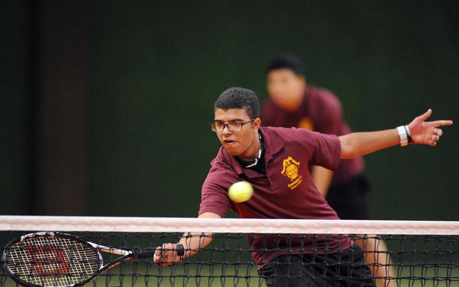 Baumholder's Joshua Milo returns a shot against Alconbury in a doubles match at the DODDS-Europe tennis championships, Thursday. Milo and his partner Robert King dropped the first-round match against Jeff Black and Joey Behr 6-1, 6-1.