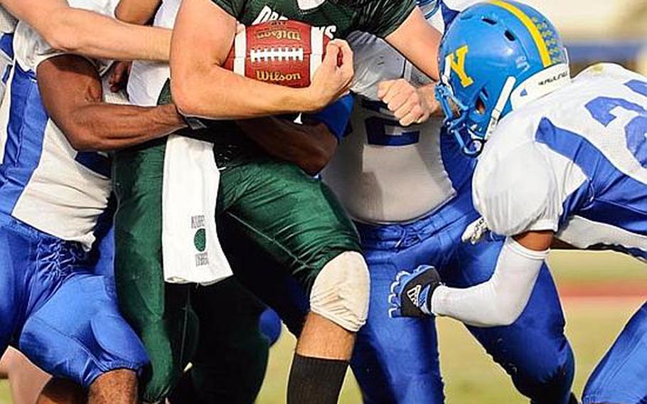 Kubasaki running back Aaron Stravers tries to negotiate his way through a scrum of Yokota defenders during Saturday's DODDS Pacific Far East Division I football game at Camp Foster, Okinawa. Yokota won 31-6.
