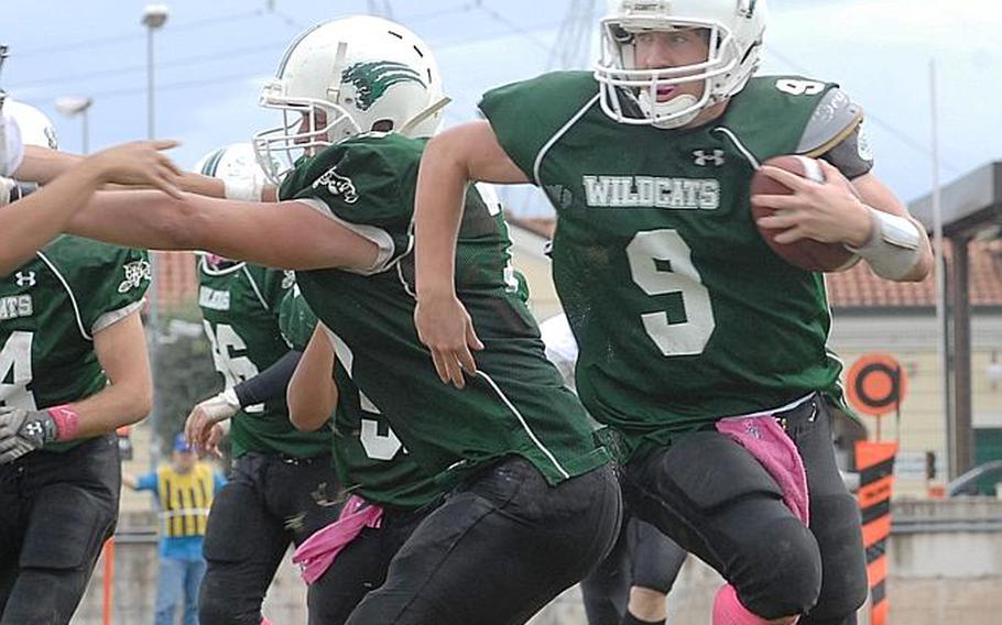 Naples senior quarterback Joseph Pitts scrambles out of the pocket and gains  a few yards Saturday in the Wildcats&#39; 21-16 victory over SHAPE in a Division II playoff game.