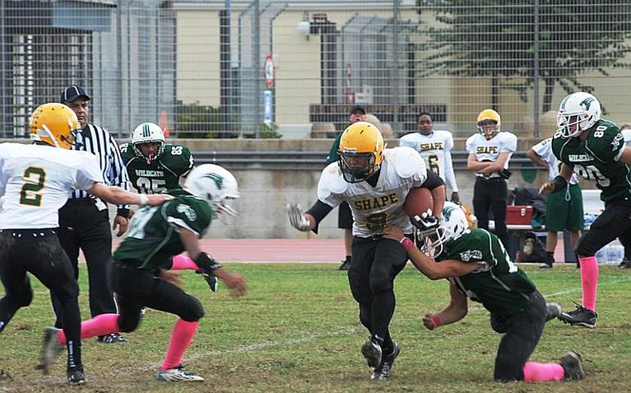 SHAPE's Conner Manning tries to find a hole in the Naples defense Saturday. The Wildcats beat the Spartans 21-16 to advance to the Division II title game.