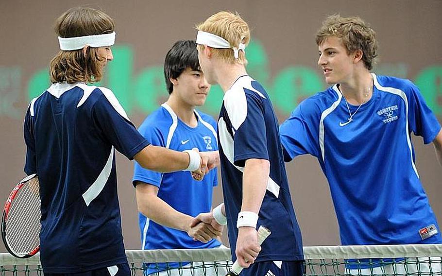 Ramstein's Lee DeBose, second from left, and Aryan Von Eicken, right, shake hands with Heidelberg's Jack Kolodziejski, left, and Wylder Raney after defeating the Heidelberg duo 6-2, 6-1 to capture the 2012 DODDS-Europe boys doubles title.