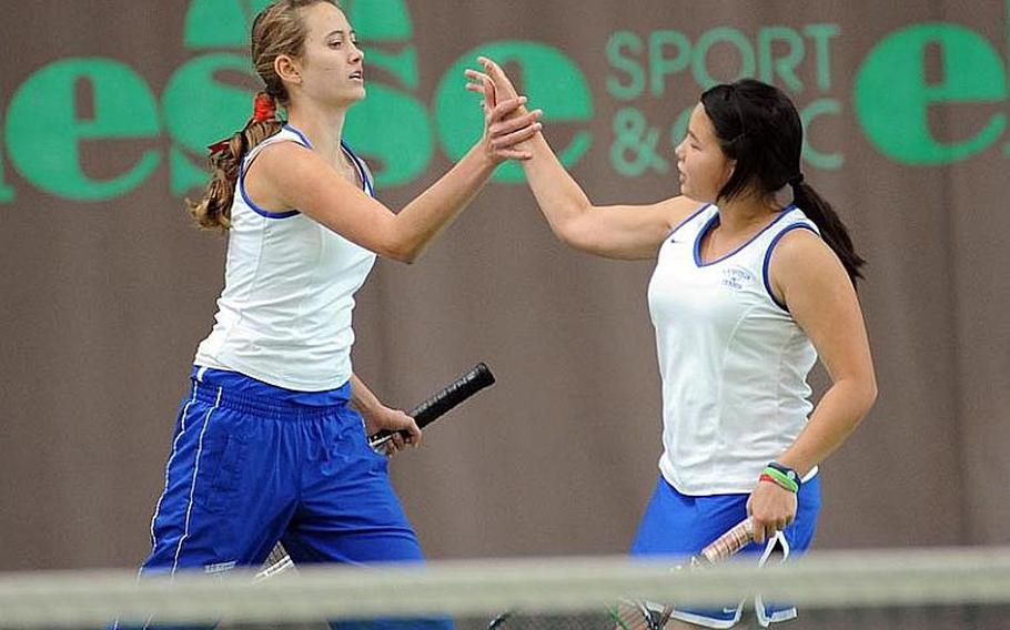 Ramstein's Sydney Townsend, left, and Jennifer DuBose  congratulate each other after scoring a point in their 7-6 (9-7), 1-6, 6-4 loss to Patch's Marina Fortun and Christine Young.