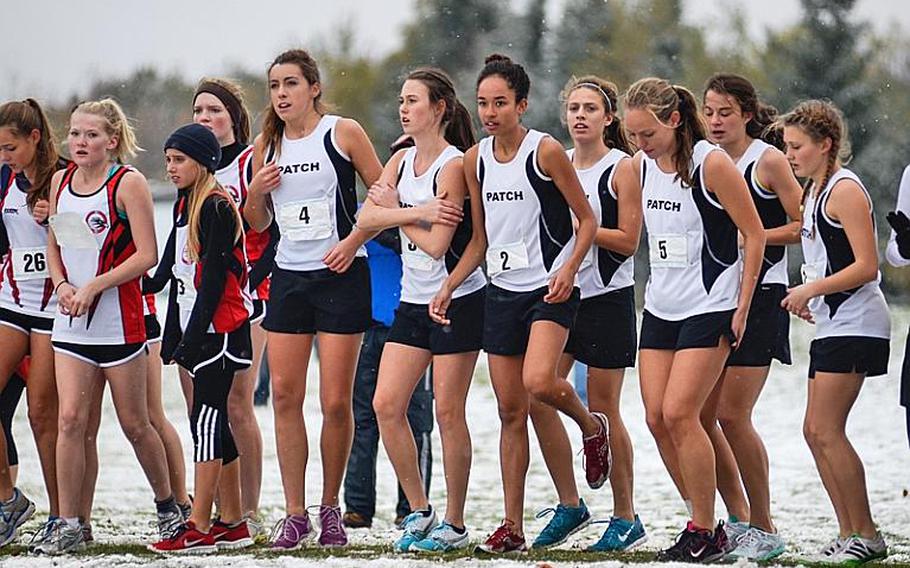 Competitors in the girls 2012 DODDS-Europe cross country championships try to stay warm at the starting line before the race started Saturday morning at the Rolling Hills Golf Course in Baumholder, Germany.