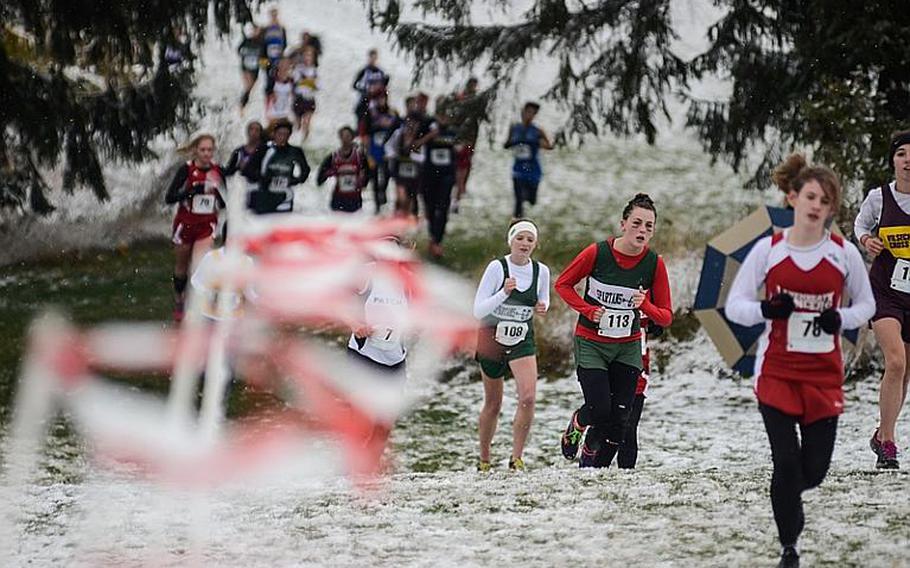 Runners run through snow and freezing temperatures in the girls 2012 DODDS-Europe cross country championships Saturday morning at the Rolling Hills Golf Course in Baumholder, Germany.