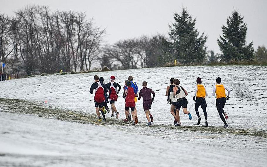 Runners in the boys 2012 DODDS-Europe cross country championships run through snowy conditions and freezing temperatures Saturday at the Rolling Hills Golf Course in Baumholder, Germany.