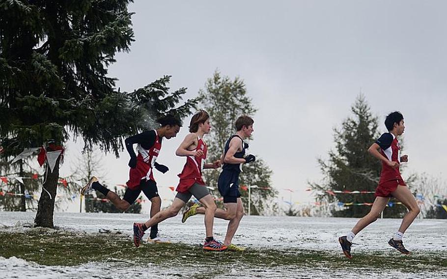 Runners in the boys 2012 DODDS-Europe cross country championships watch their steps as the snowy course was slick Saturday at the Rolling Hills Golf Course in Baumholder, Germany.