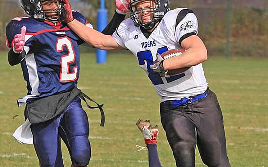 Hohenfels' David Vidovic stiff-arms Bitburg's C.J. Evans  during Saturday's Division II playoff game at Bitburg.