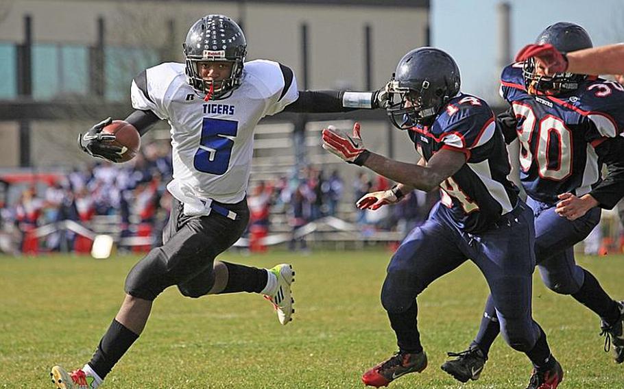 Hohenfels freshman Kordell Craft stiff-arms Bitburg's Larry Jackson in Saturday's Division II playoff at Bitburg.