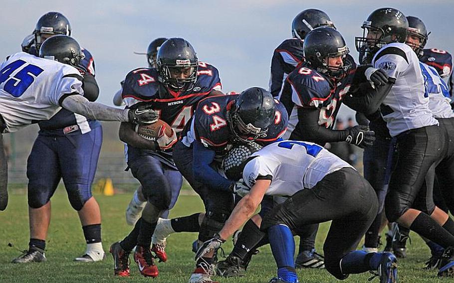 Bitburg running back Larry Jackson follows teammate Bryson Randall through a hole in the Hohenfels Tigers defense Saturday in their Division II playoff at Bitburg.