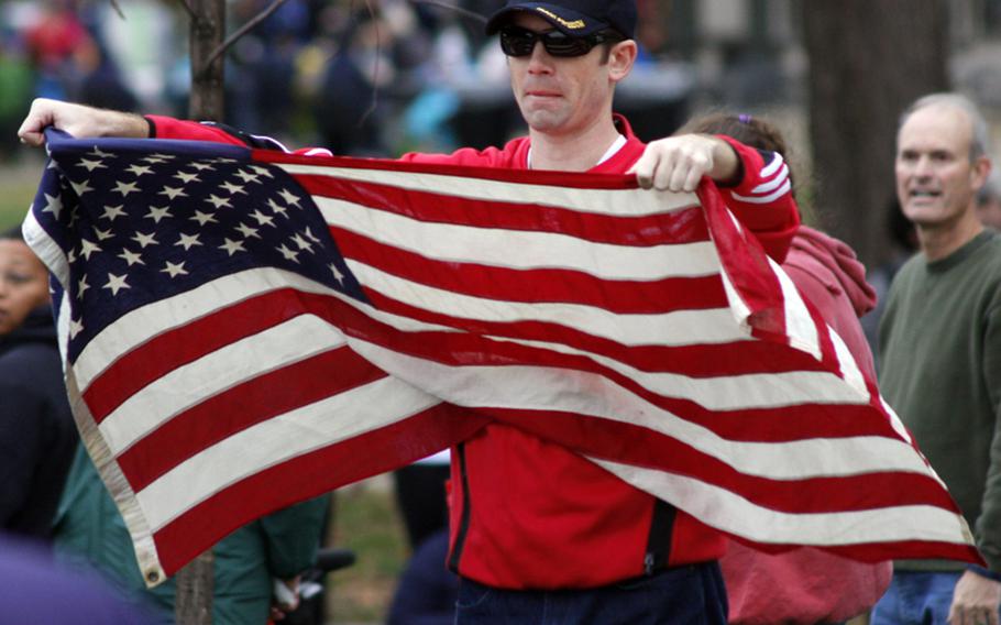 A spectator displays the colors at the Marine Corps Marathon.