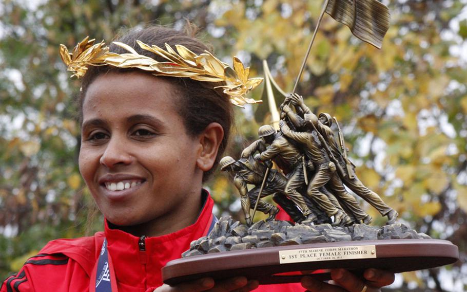 Hirut Guangul displays her trophy after winning the women's division of the Marine Corps Marathon on Oct. 28, 2012. Guangul finished with a time of 2:42:03.