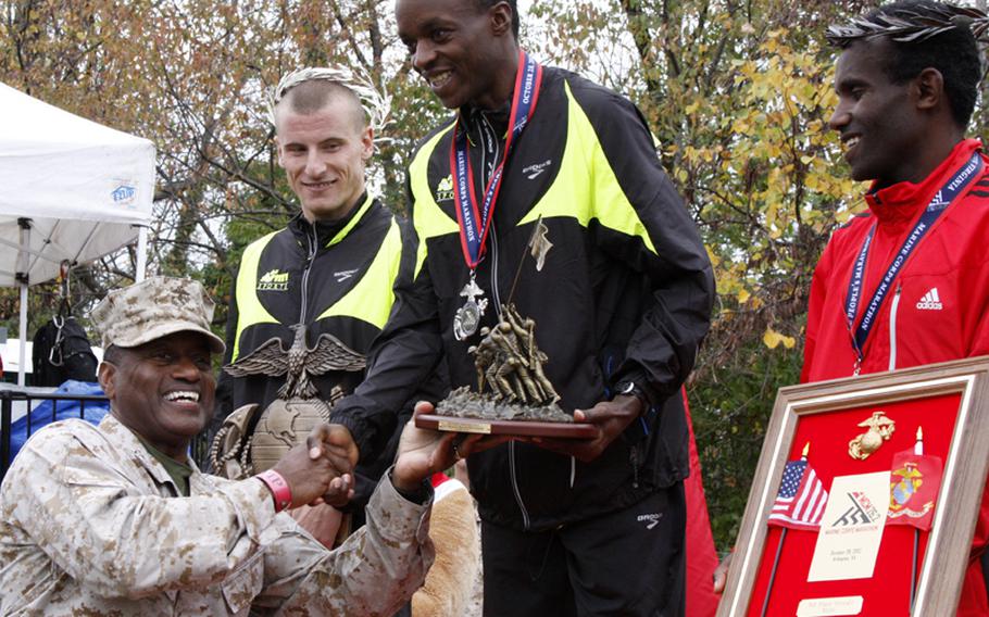 Marine Lt. Gen. Willie Williams congratulates men's winner Army Spc. Augustus Maiyo at the Marine Corps Marathon on Oct. 28, 2012. Maiyo finished with a time of 2:20:20. 