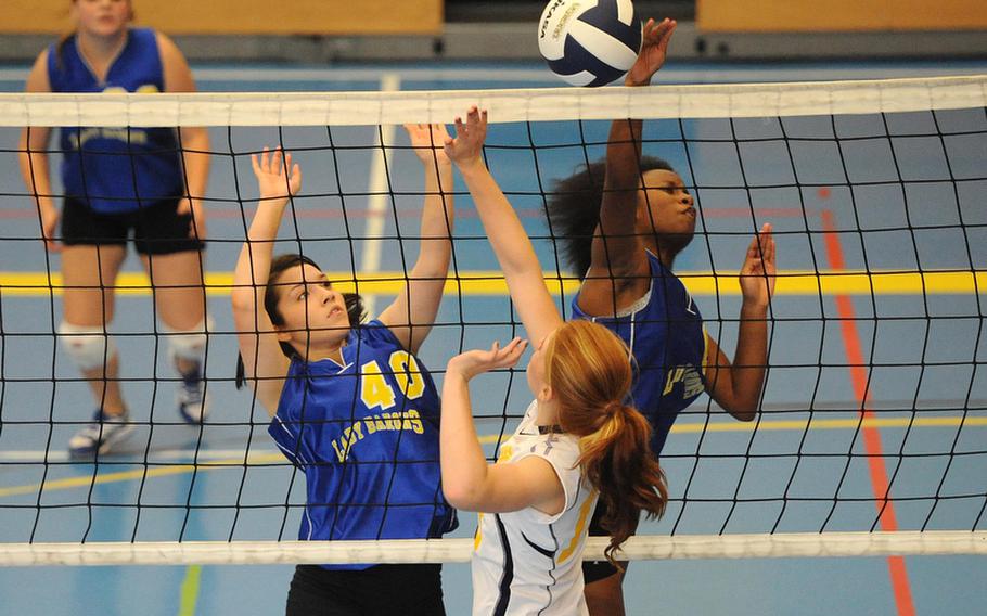 Bamberg's Kiyamah Lambert, right gets the ball over the net and past Heidelberg's Larla Halsey for a point as teammate Arianna Gonzales gets in on the action. Heidelberg won the match at home on Oct. 6, 25-8, 25-17, 25-10. Heidelberg will be playing Division I and Bamberg Division III when the DODDS-Europe volleyball championships that get under way Thursday in the Kaiserslautern Military Community.