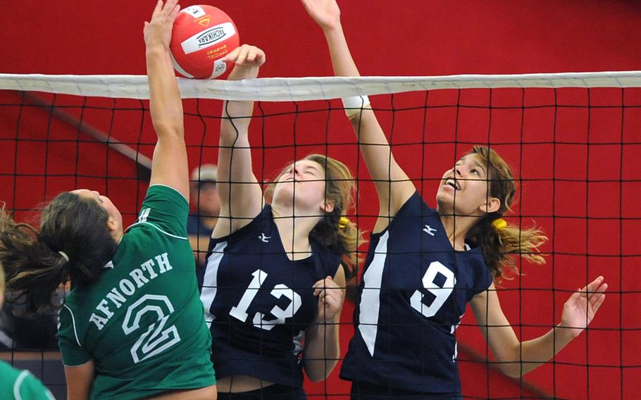 AFNORTH's Madison Puckett tries to get the ball over the net against the defense of Bitburg's Brandy Oliver, center, and Allison Lillemon, in a match in Kaiserslautern on Sept. 22. Both teams will be competing in Division II when the DODDS-Europe volleyball championships that get under way Thursday in the Kaiserslautern Military Community.