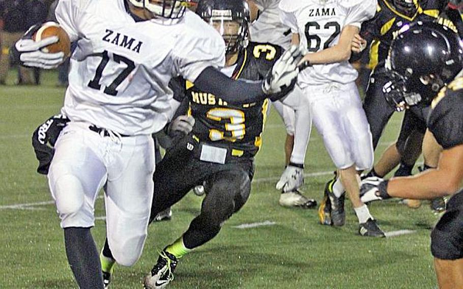 Zama American running back Mitchell Harrison looks for running room against American School In Japan  defense during Friday's Kanto Plain Association of Secondary Schools football game in Tokyo. ASIJ came back from a 19-7 deficit to win 20-19.