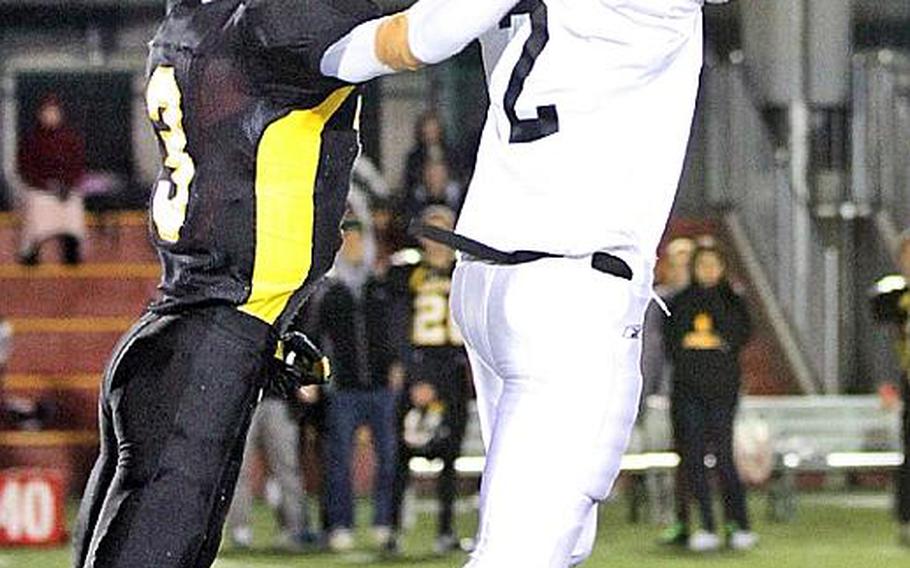 Zama American receiver David Coleman leaps for a pass against American School In Japan defender Ken Yajima during Friday's Kanto Plain Association of Secondary Schools football game in Tokyo. The pass went incomplete. ASIJ came back from a 19-7 deficit to win 20-19.