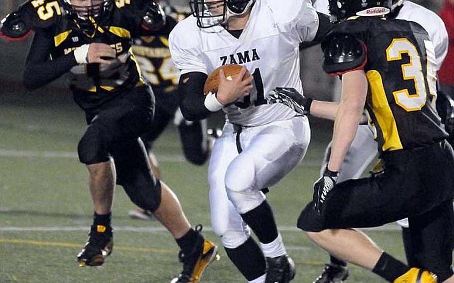 Zama American ball carrier Andre Encarnacion tries to avoid American School In Japan Mustangs Max Linder, left, and Wills Wallrapp during Friday's Kanto Plain Association of Secondary Schools football game in Tokyo. ASIJ came from behind 19-7 to win 20-19.