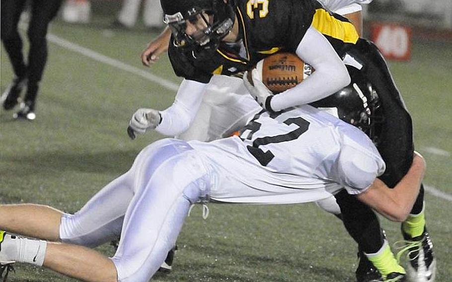 American School In Japan ball carrier Ken Yajima is brought down by Zama American defender Kalob Gunn during Friday's Kanto Plain Association of Secondary Schools football game in Tokyo. ASIJ came from behind 19-7 to win 20-19.