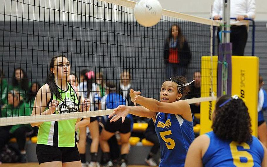 Sigonella's Deeanna Brown set the ball as teammate Dinayda Garcia-Diaz and Alconbury's Hailey Sorensen watch. Sigonella won the match 25-20, 25-23, 22-25, 23-25, 15-13 and will face Rota for the title.