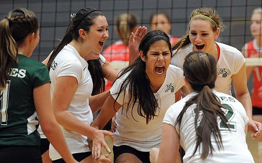 Isabel Krause of Naples, center, celebrates a kill against American Overseas School of Rome with her teammates in a Division II semifinal at the DODDS-Europe volleyball finals. Naples won 25-22, 25-18, 25-13.