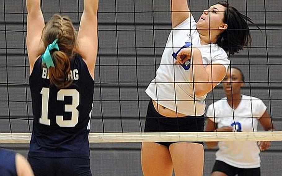 Ansbach's Alyssa Solis hits a ball across the net against Bitburg's Brandy Oliver in a Division II semifinal at the DODDS-Europe volleyball finals. Ansbach won the match 25-13, 25-17, 25-21.