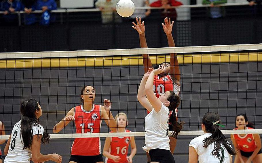American Overseas School of Rome's Margo Snipe goes high in a block attempt against Logan Percival of Naples in a Division II semifinal at the DODDS-Europe volleyball finals. Watching the action from left are Isabel Krause, Caterina Fantetti ,Olivia Mansager and Carina Cusumano. Naples won 25-22, 25-18, 25-13.