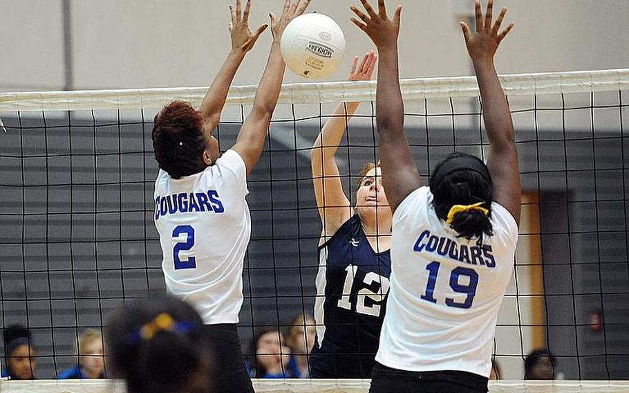 Bitburg's Lydia Horn puts the ball between Ansbach defenders Caprice Lockett, left, and Adreana Cunningham in a Division II semifinal at the DODDS-Europe volleyball finals. Ansbach won the match 25-13, 25-17, 25-21.