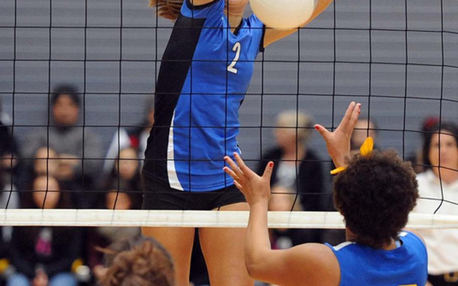 Rota's Aspen Luna slams a ball back across the net for a point in front of Sigonella's Allison Cruz, left, and Sydney Moore in the Division III final at the DODDS-Europe volleyball championships. Rota took its third straight Division III title with a  25-18, 25-23, 25-19 win.