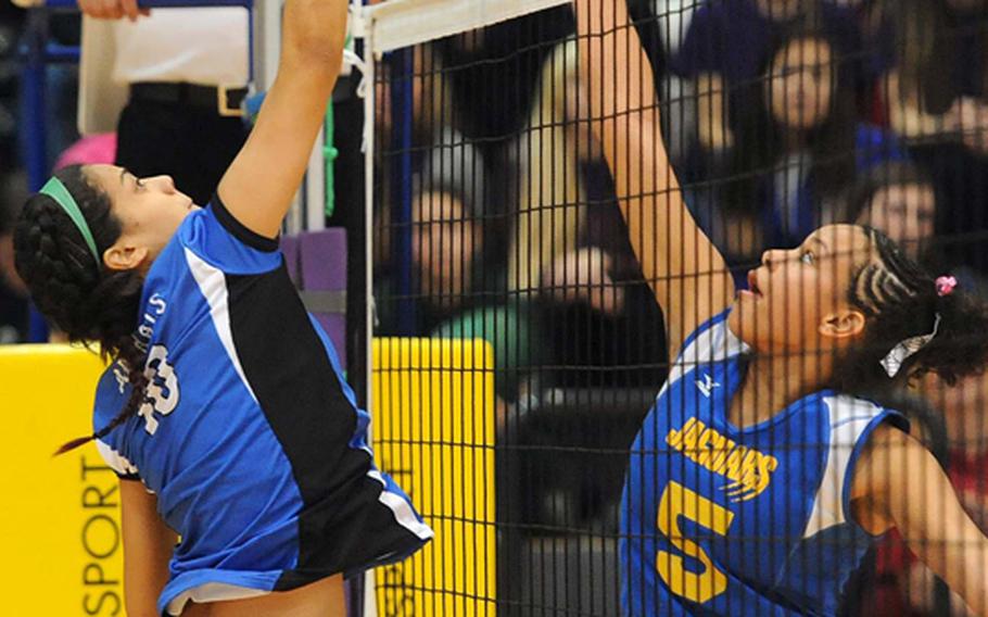 Rota's Natalia Rivera, left, and Sigonella's Deeanna Brown battle at the net in the Division III final at the DODDS-Europe volleyball championships. Rota took its third straight Division III title with a  25-18, 25-23, 25-19 win.