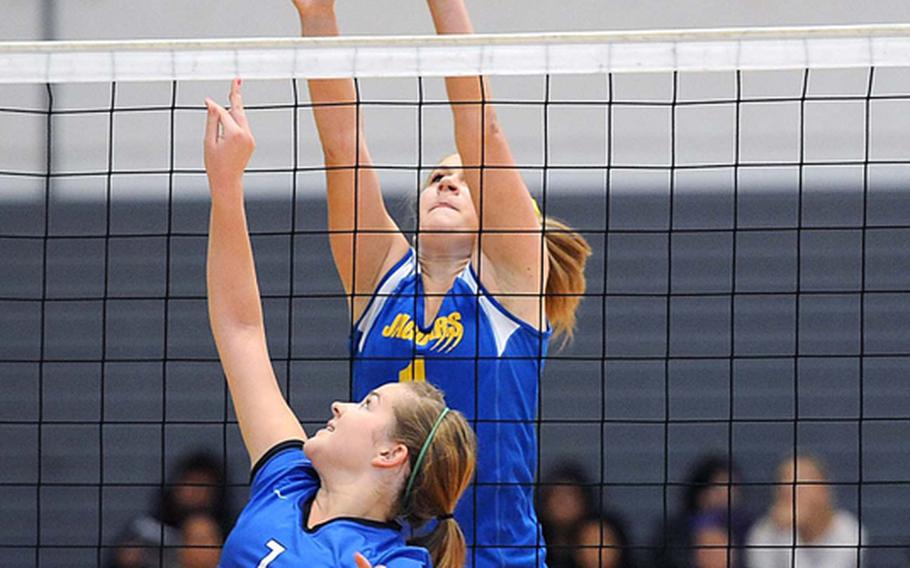 Rota's Hailey Landry, foreground, attempts to get the ball over Sigonella's Rachel Vosler in the Division III final at the DODDS-Europe volleyball championships. Rota took its third straight Division III title with a  25-18, 25-23, 25-19 win.