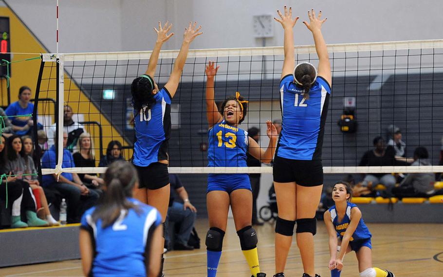 Sigonella's Sydney Moore gets the ball between Rota's Natalia Rivera, left, and Keziah Anderson for a point in the Division III final at the DODDS-Europe volleyball championships. Rota took its third straight Division III title with a 25-18, 25-23, 25-19 win.
