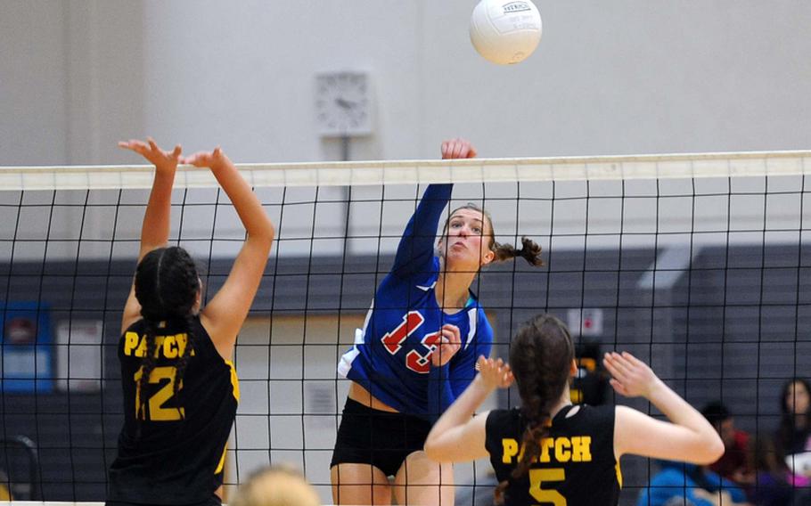 Ramstein's Sarah Szybist slams the ball past Patch's Mercedes Deets, left, and Adrianna Callahan in the the Division I final at the DODDS-Europe volleyball championships in Ramstein, Saturday. The Royals beat Patch 25-12, 25-14, 25-19 to defend their title.