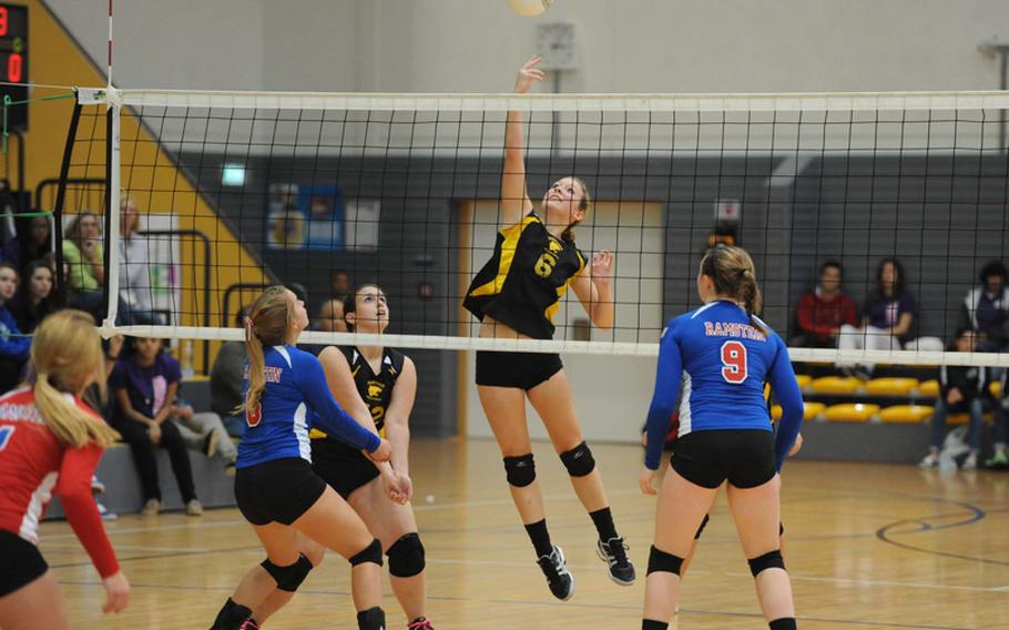 Patch's Rachel Hess hits the ball between the defense of Ramstein's Shannon Guffey, left, and Sarah Schiller in the the Division I final at the DODDS-Europe volleyball championships in Ramstein, Saturday. The Royals beat Patch 25-12, 25-14, 25-19 to defend their title.