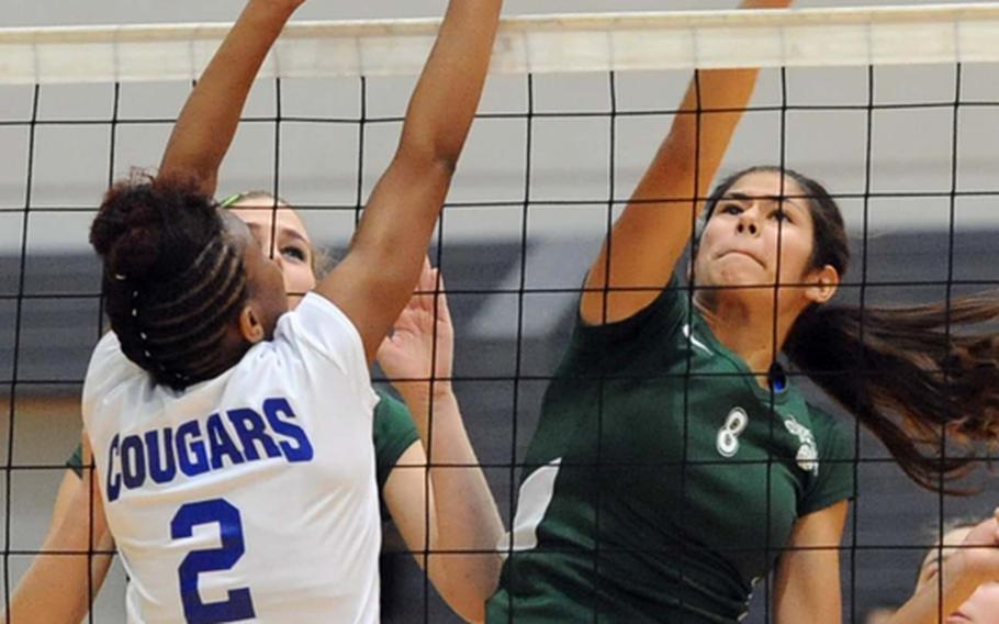 Isabelle Krause of Naples hits the ball past Ansbach's Caprice Lockett in the Division II title match at the DODDS-Europe volleyball championships in Ramstein, Saturday. The defending champs beat Ansbach 23-25, 25-20, 25-17, 25-18.