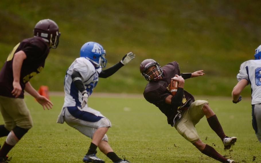 Baumholder's Ben McDaniels loses his footing in the Buccaneers' 26-0 win over the Rota Admirals in the wet 2012 DODDS-Europe Division III football championship Saturday afternoon in Baumholder, Germany.