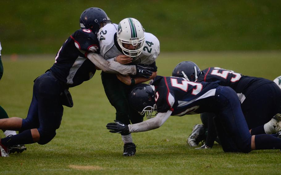 Naples' Tyler Williams is taken down by several Bitburg Barons Saturday evening in the 2012 DODDS-Europe Division II football championships in Baumholder, Germany.