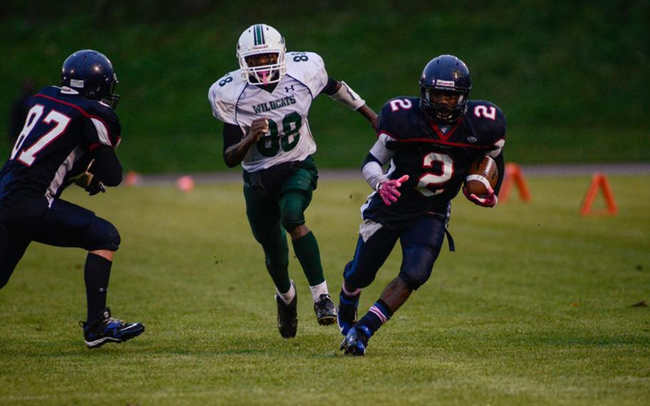 Bitgurg's CJ Evans picks up a first down Saturday evening in the 2012 DODDS-Europe Division II football championship in Baumholder, Germany. Bitburg edged Naples 22-20 to win its record fourth championship in a row.