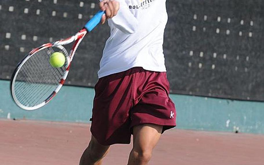 Matthew C. Perry's Sam Cadavos hits a net-approach forehand against Seoul American 's Andrew Clark during Thursday's boys third-place match in the Far East High School Tennis Tournament at Kadena Air Base, Okinawa. Cadavos won 8-2.